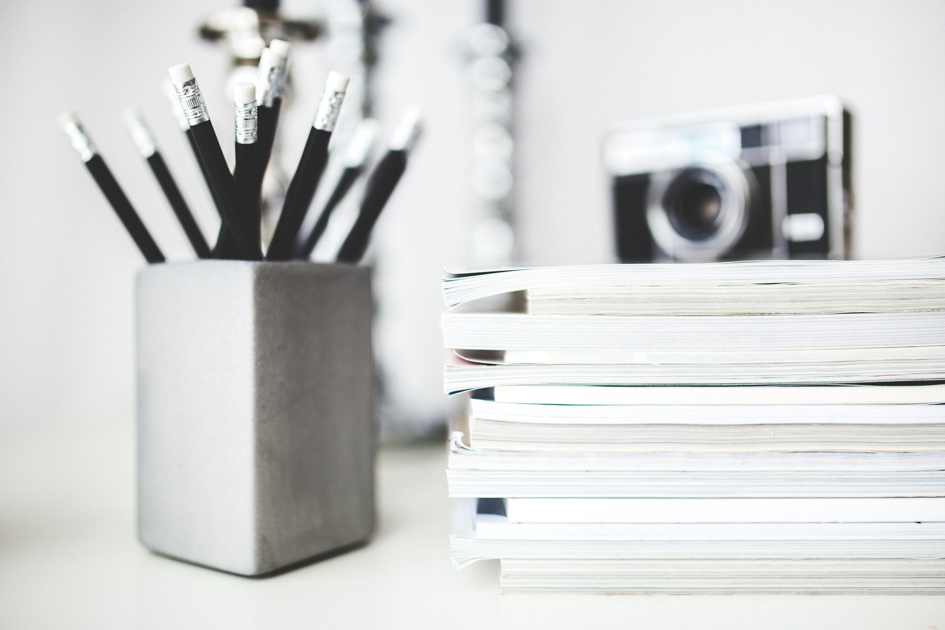 Press and Media work space pencils next to magazines